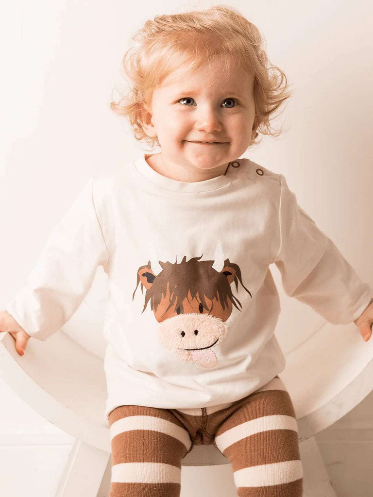 Blade and Rose Neutral Hamish Cow Top - bold, bright and fun! This gorgeous cream top features a cute neutral Hamish Cow design. model.