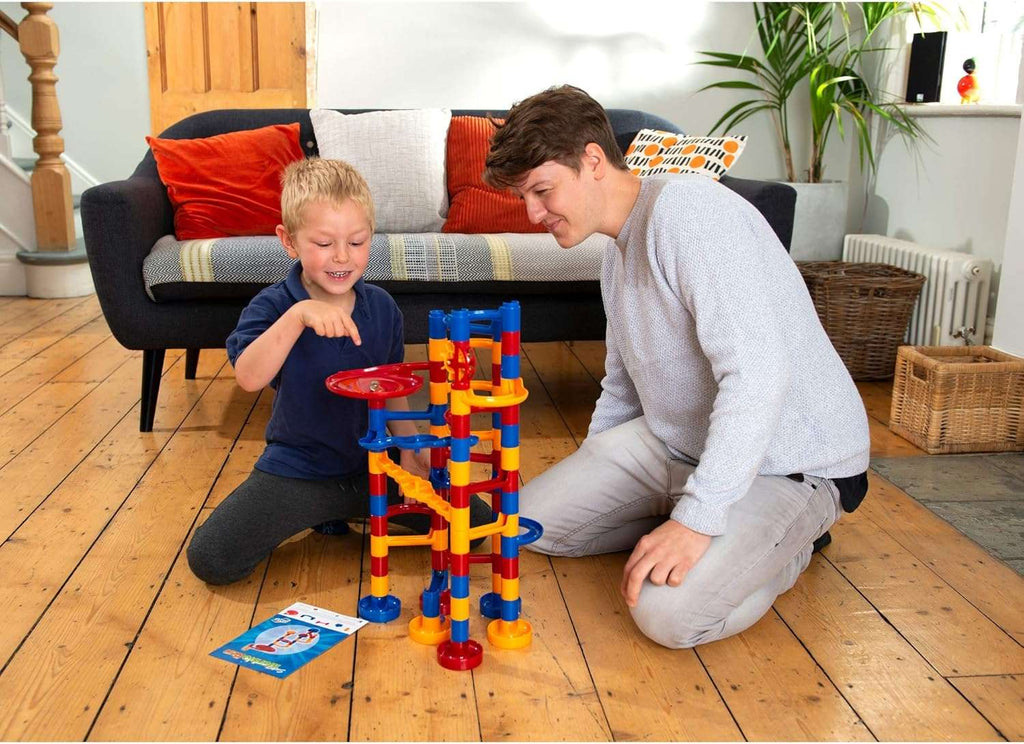 Galt Super Marble Run. Two children playing with a colorful marble run set on a wooden floor.