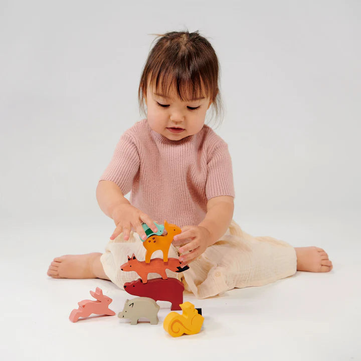 Mentari Happy Stacking Forest. Child playing with colorful wooden toys on a white background