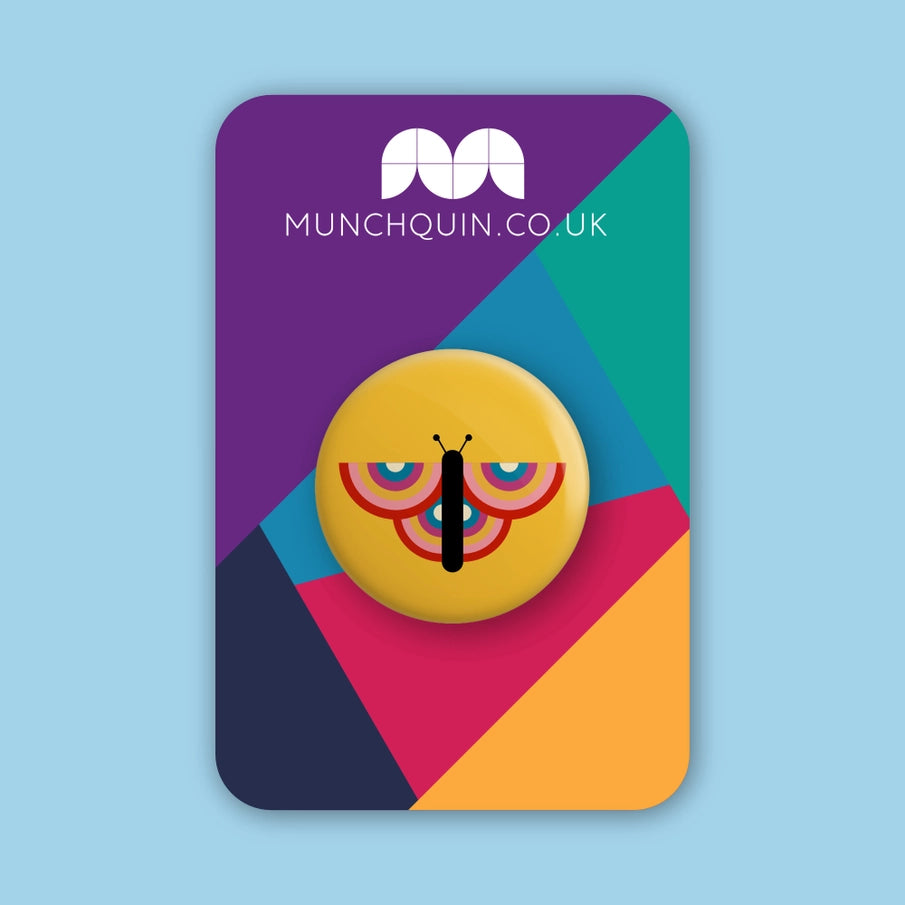Hey There Munchquin Retro Butterfly Button Badge - a quirky and fun pin badge featuring a retro rainbow butterfly on a yellow background.