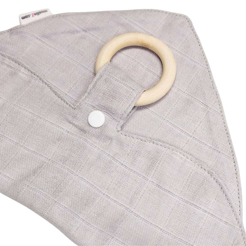 Muslinz Mini Muzi - Sensory. Gray textured fabric with a wooden ring and white button on a white background