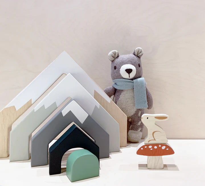 Tender Leaf Mountain Stack -  Wooden toy houses and a teddy bear with a scarf on a light background