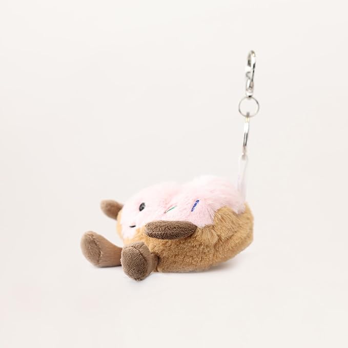 Warmies Donut Bag Charm - Plush doughnut keychain with a smiling face on a cream background - side view