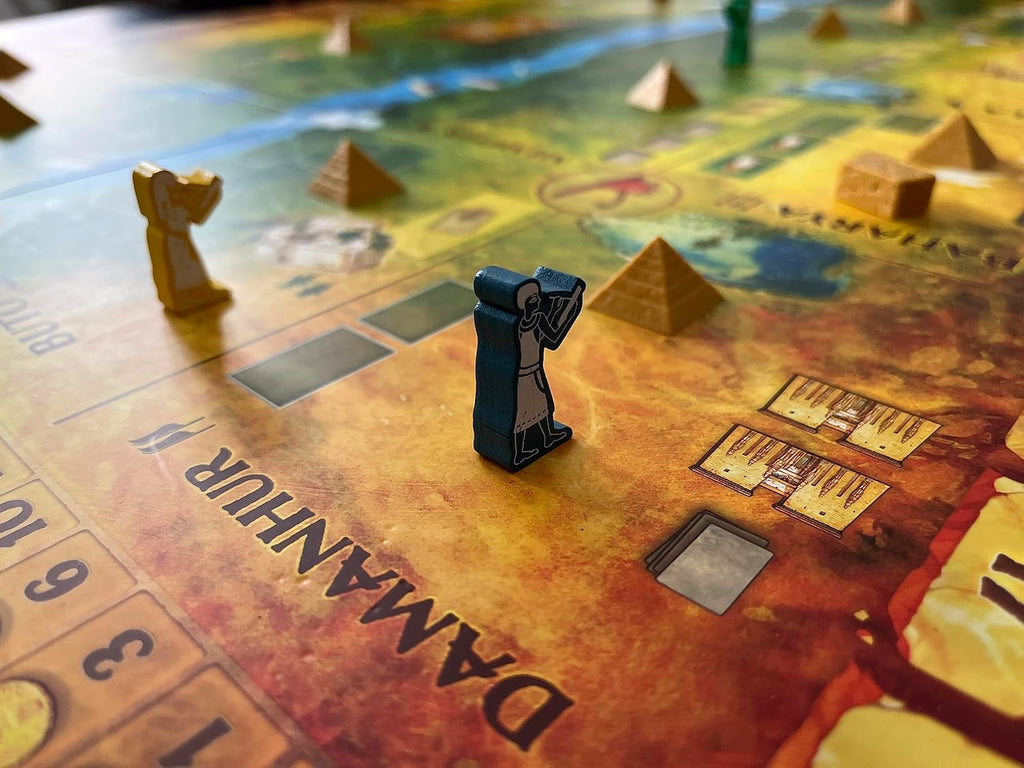 Board game piece on a game board with pyramids and text