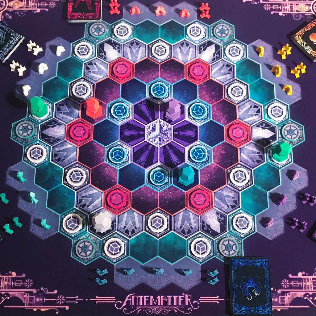 Hexagonal tile game with colorful tiles on a matching board, featuring the brand 'Antemater'. 