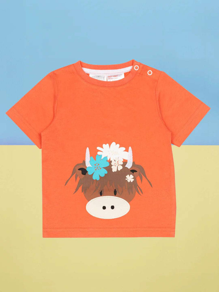 This gorgeous bright orange short-sleeved t-shirt features a cheeky Highland Coo Bonnie face with pretty floral detail by Blade and Rose
