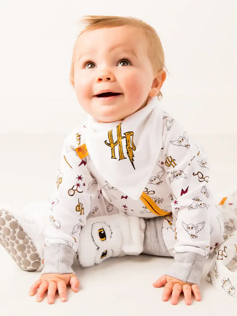 Blade & Rose Harry Potter Hedwig Bibs (Pack of 2). Baby wearing a Harry Potter-themed onesie on a white background