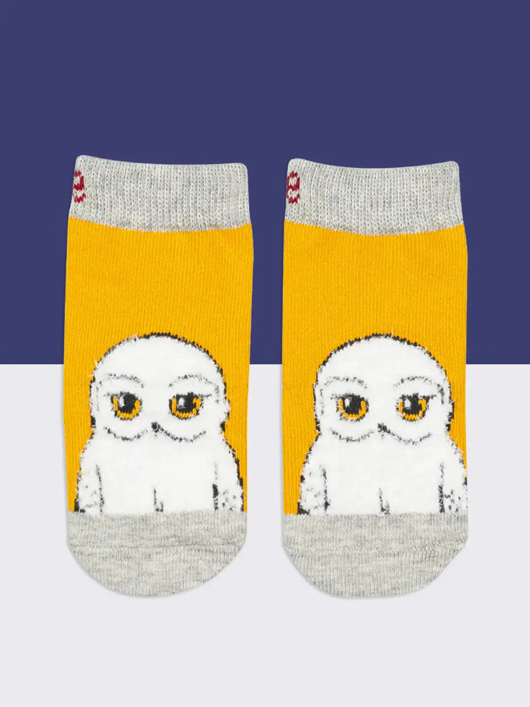 Blade & Rose Harry Potter Hedwig Owl Socks. Pair of socks with owl design on a yellow background