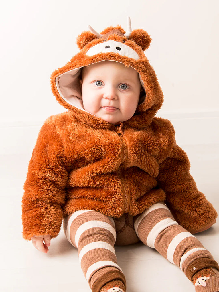Blade & Rose Netural Highland Cow Hoodie. Baby wearing a brown fuzzy cow hoodie on a white background