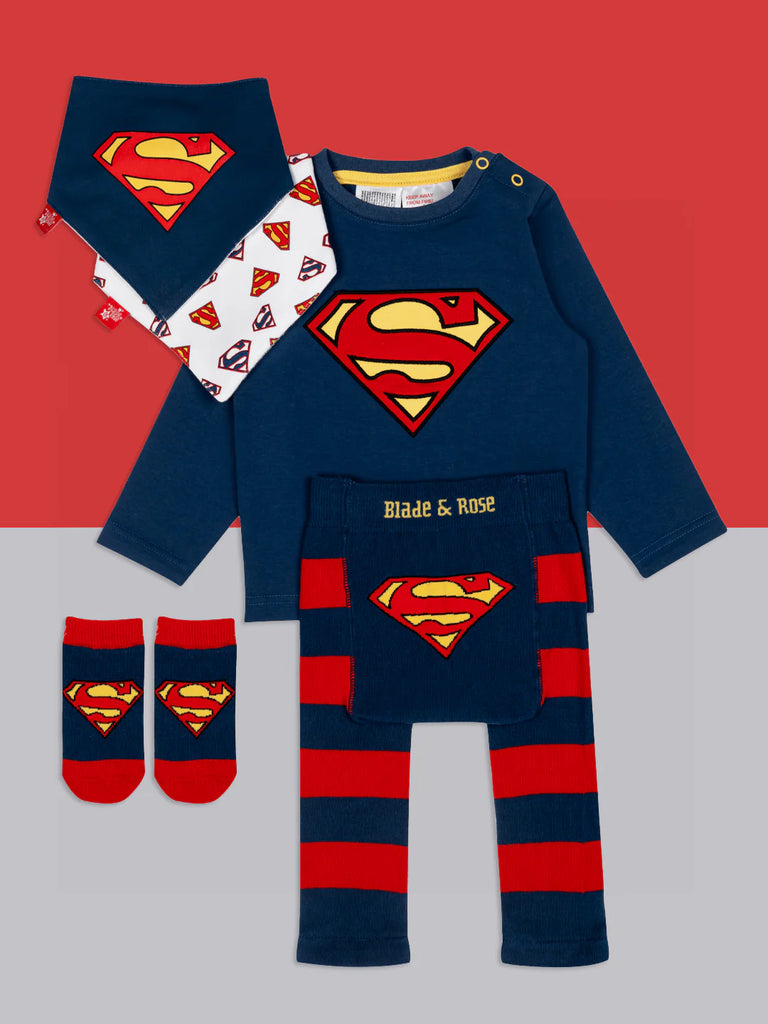 Blade & Rose Superman Leggings. Superman-themed baby outfit with shirt, pants, socks, and bib on a red and gray background