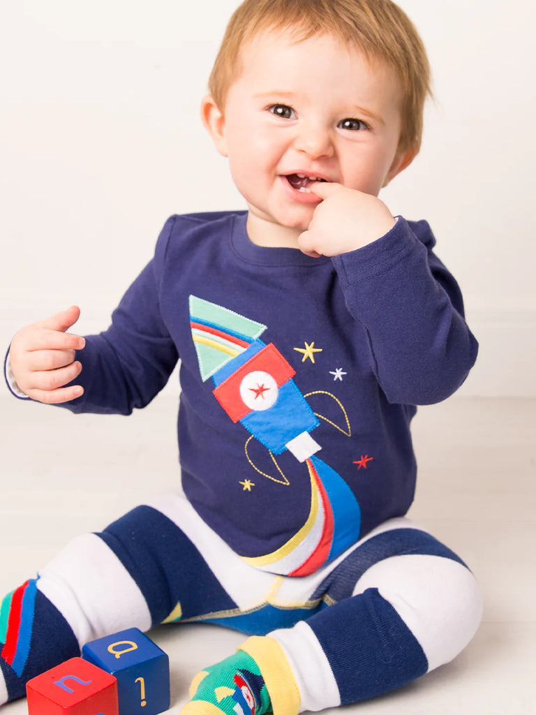 To The Moon And Back Top - bold, bright and fun! This gorgeous navy blue top features a bold and colorful rocket ship applique design on the front, perfect for any aspiring astronaut!