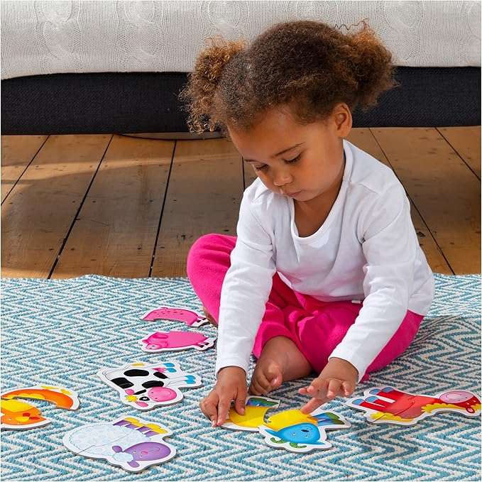 Galt Baby Puzzle - Farm. Child playing with colorful foam animals on a patterned rug.