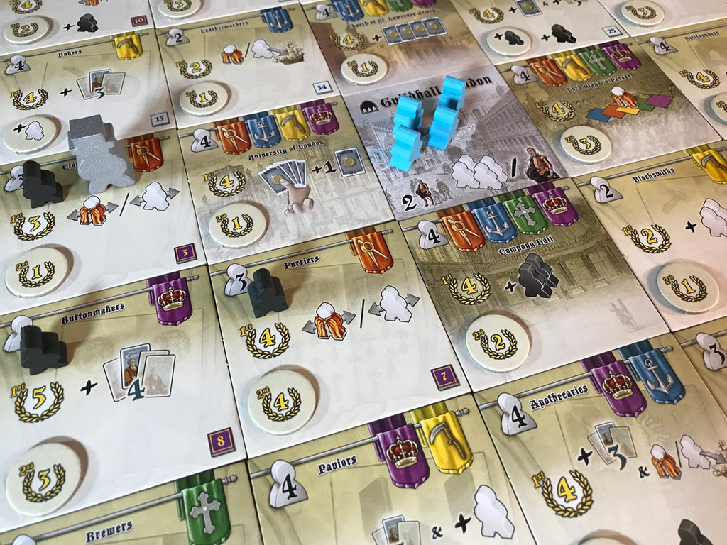 Board game with various pieces and cards on a grid layout