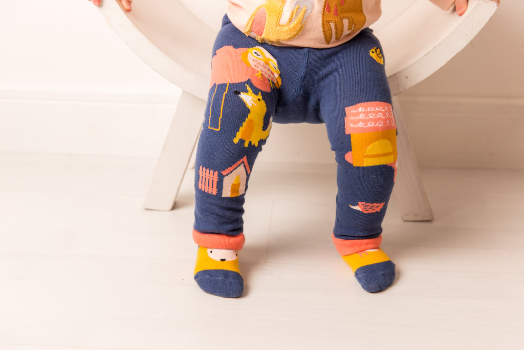 Blade & Rose Meadow Farmyard Socks. Child wearing colorful leggings with animal prints on a white background