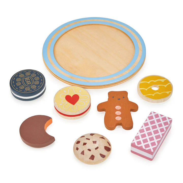 Mentari Tea Time Biscuit Plate. Wooden toy baking set with a round wooden board and various shaped cookies on a white background