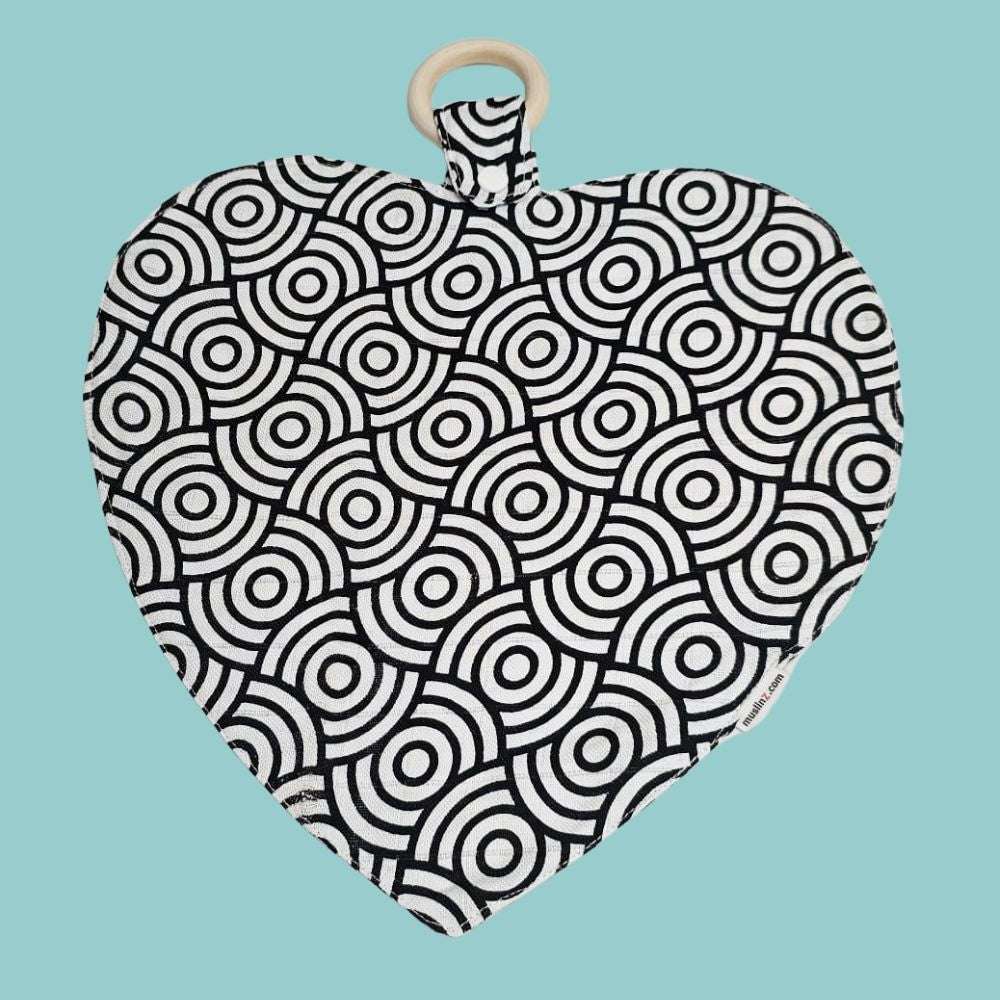 Muslinz Mini Muzi - Sensory Heart-shaped muslin with black and white circular pattern on a blue background