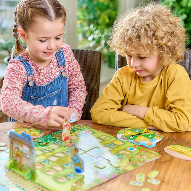 Orchard Toys Peter Rabbit Don't Wake Mr. McGregor Game. Two children playing with a board game on a wooden table.