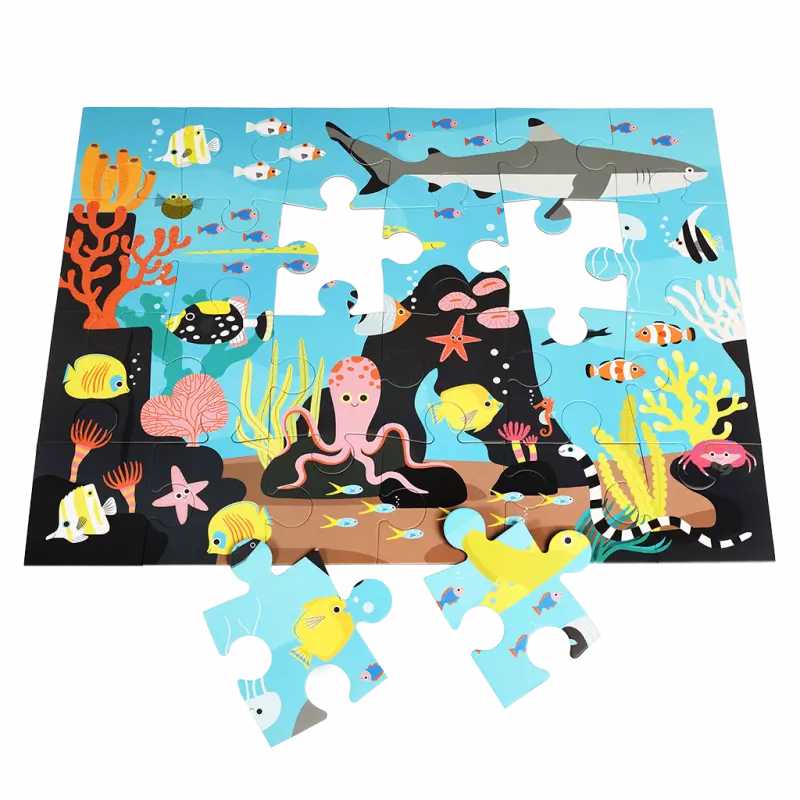 Children's puzzle with ocean-themed design featuring fish, sharks, and coral on a blue background.