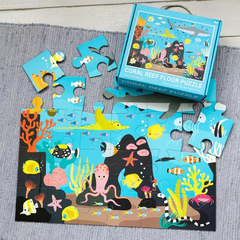 Coral reef-themed children's puzzle with pieces scattered on a gray surface