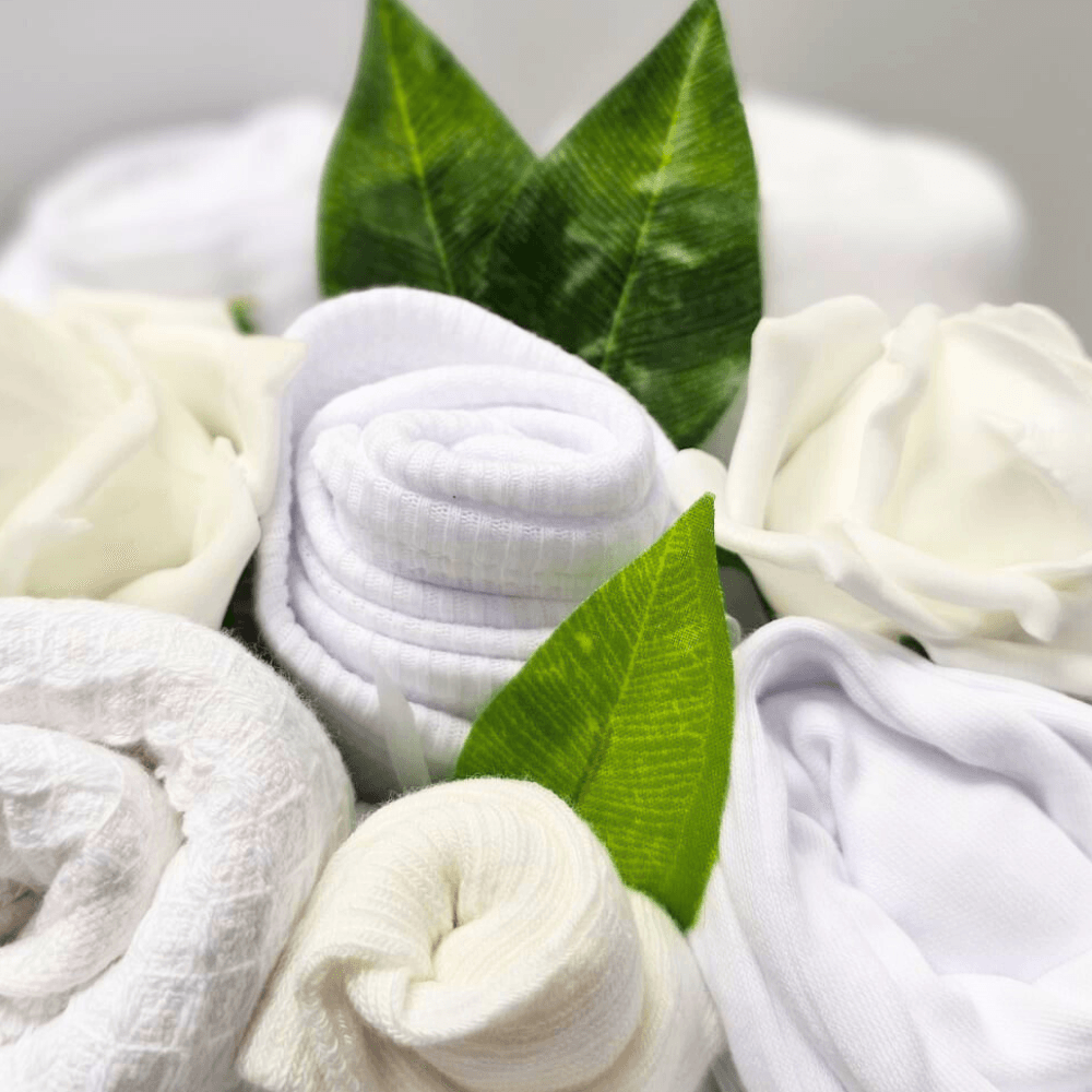 Say It Baby - Unisex Baby Clothes Bouquet. Send new baby wishes with this lovely baby bouquet arrangement in white and cream.