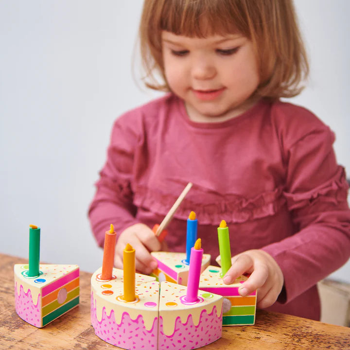 Tender Leaf Rainbow Birthday Cake. Child playing with a colorful wooden birthday cake toy