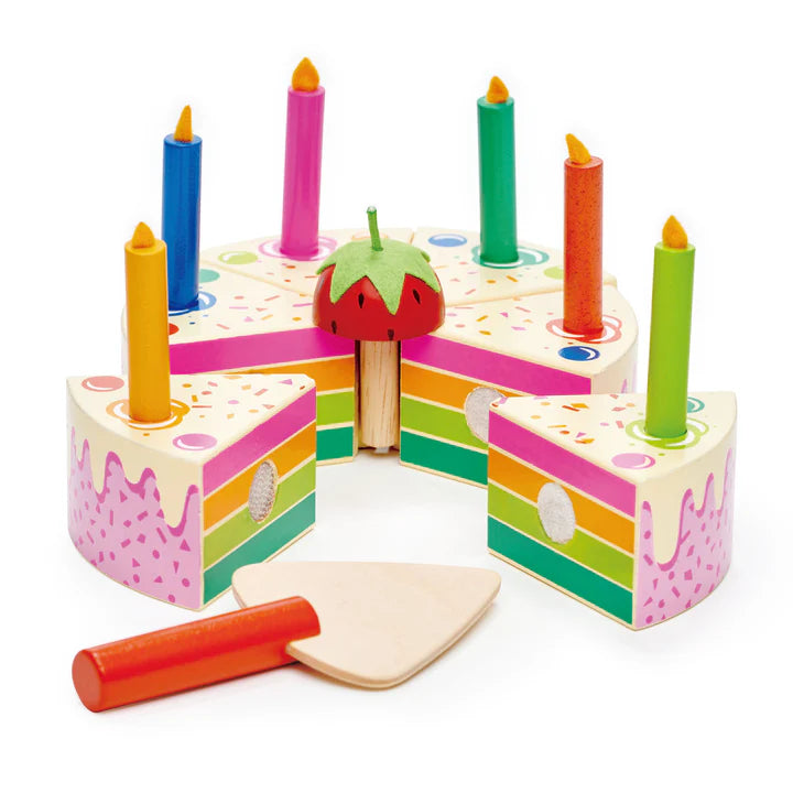Tender Leaf Rainbow Birthday Cake. Colorful wooden cake toy with candles and a knife on a white background