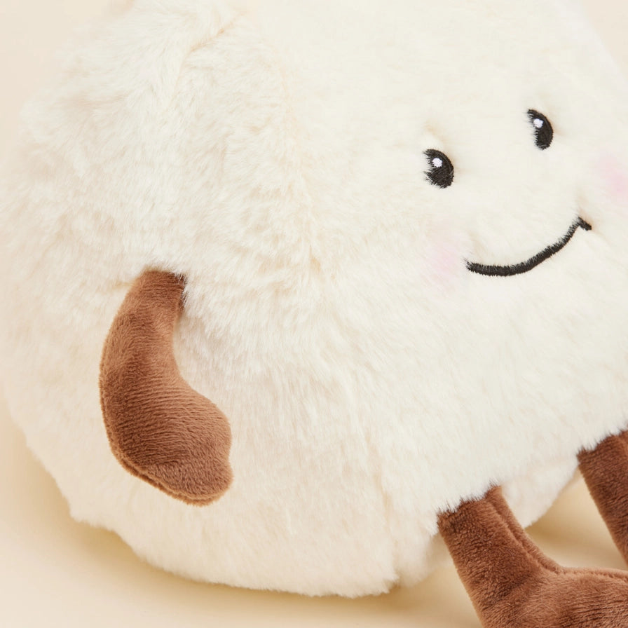 Warmies Dumpling - Plush toy dumpling with a smiling face on a beige background