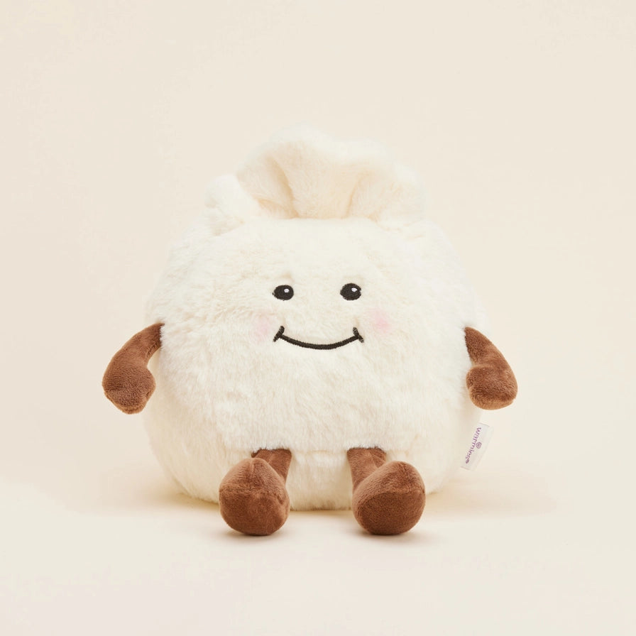 Warmies Dumpling - Plush toy sheep with a smiley face on a beige background
