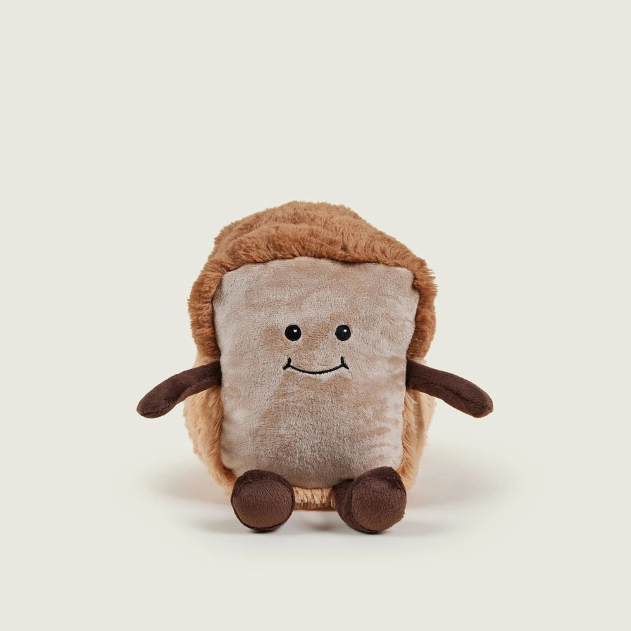 Warmies Loaf of Bread - Plush toy loaf with a smiling face on a beige background front view