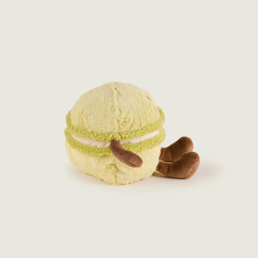 Warmies Macaroon - Plush toy macaron with a smiley face on a beige background - back view