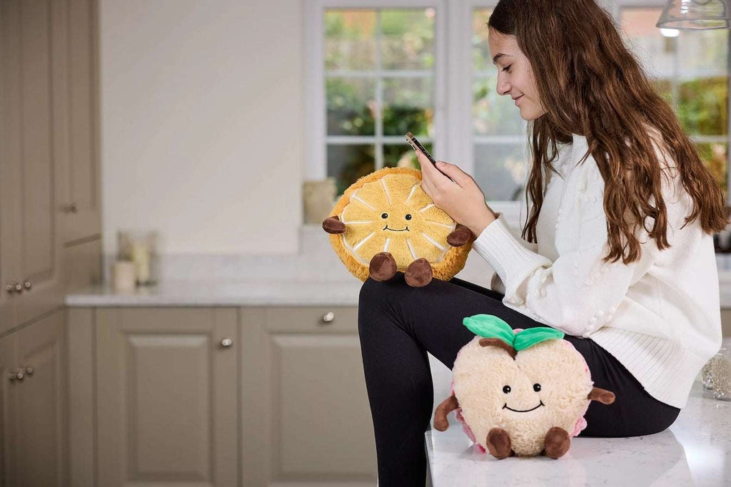 Warmies Orange Plush toy orange with a smiling face - in kitchen