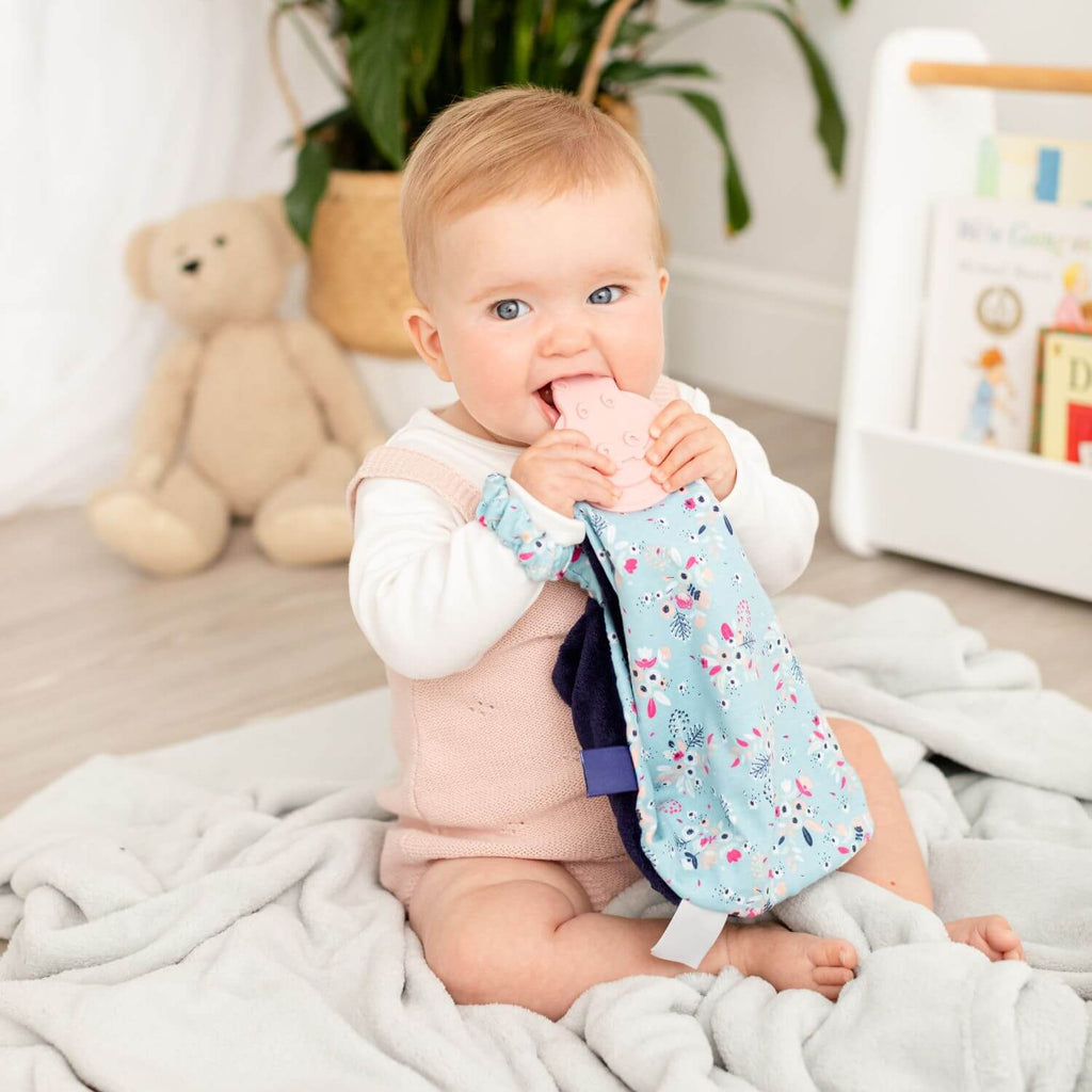 Cheeky Chompers Botanical Bloom Comforter & Teether. With handy elasticated strap, it can also be easily attached to the pram or baby's wrist for on-the-go chewing! A fab gift for baby.