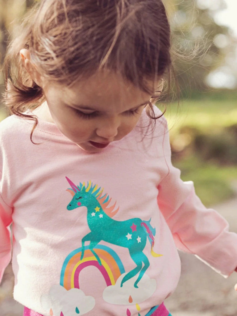 Blade & Rose Magical Sparkly Unicorn Top- bold, bright and fun! This gorgeous pastel pink top features a magical, mystical, flying unicorn, and most importantly, it sparkles! Sold by Say It Baby Gifts