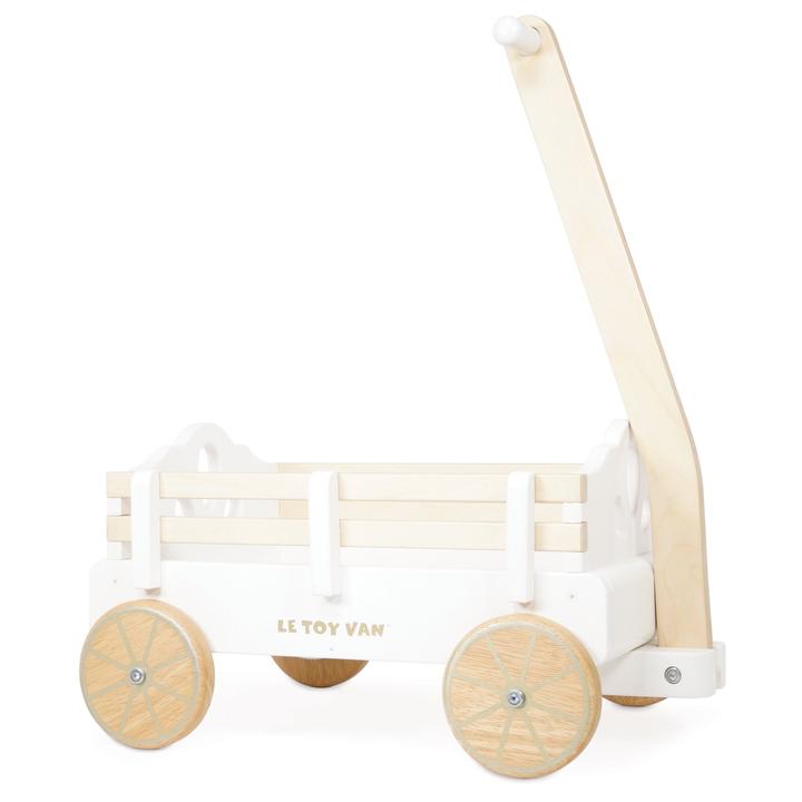 Le Toy Van Pull Along Wagon Cart. This timeless wagon is ideal for kids to collect, load and transport toys their around the house. This robust wagon is made from sustainable rubberwood and solid strong plywood and can be pulled along floors and carpets seamlessly.