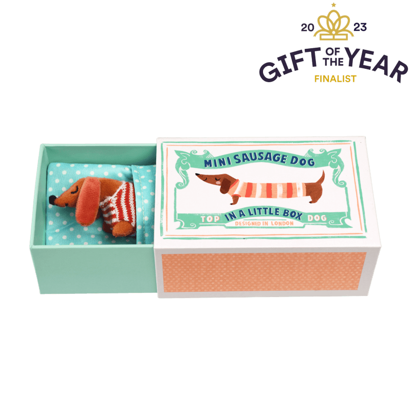 Rex London. This mini sausage dog in a little box soft toy is just so adorable with his striped shirt and red polka dot blanket! Sold by Say it Baby Gifts