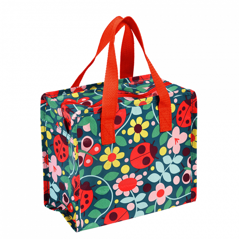 This fabulous Ladybird design Charlotte Bag features a colourful ladybird and flower design on a dark blue background with bright red handles. Say It Baby Gifts