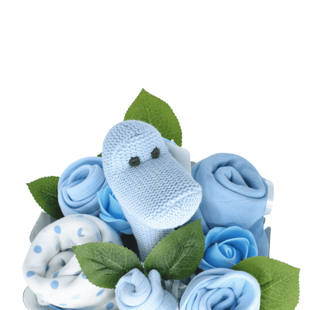 Say It Baby - Sweet Baby Blue Dino Bouquet. The bouquet box contains muslin squares, baby bibs, socks and a gorgeous Best Years Diplodocus Dino in blue The sweet dino is made from organic cotton and features a gentle rattle.
