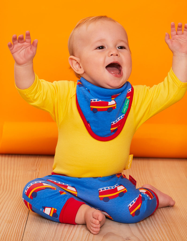 A bold fire engine themed Dribble Bib made with 100% organic cotton, super soft and lined with towelling for extra absorbency.